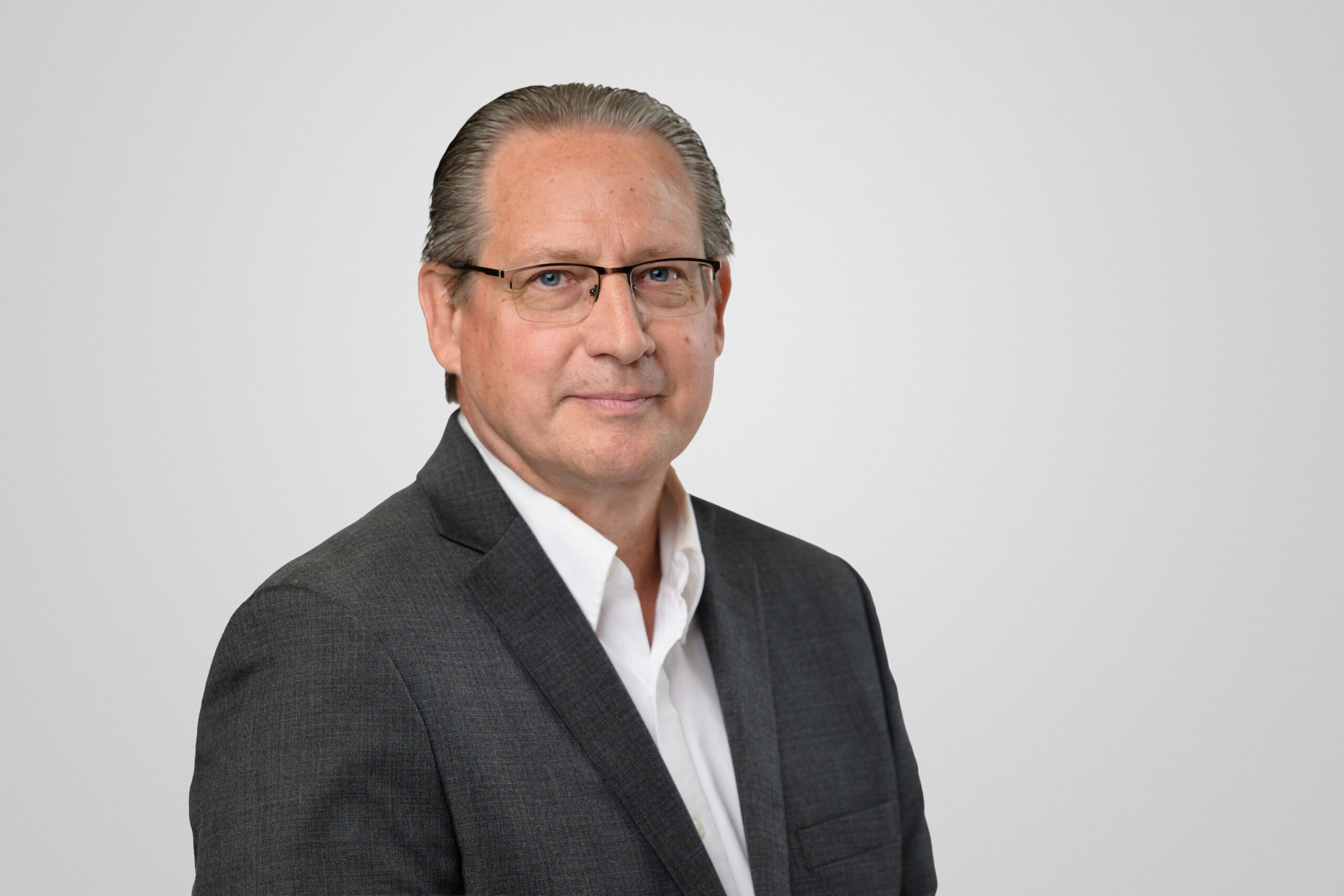 Marty Ellman professional headshot in front of a light gray background