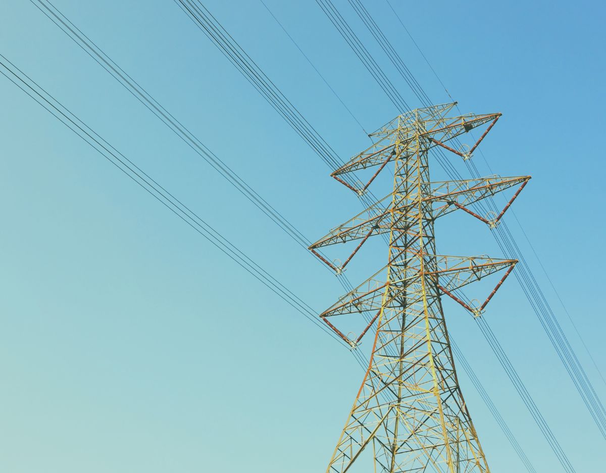 Transmission power line in front of a blue sky