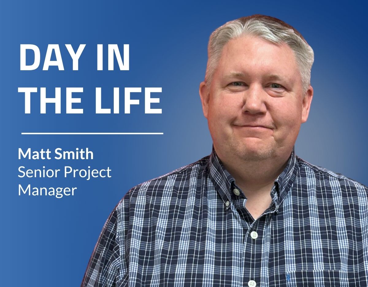 Promotional graphic with a blue gradient background featuring a headshot of a person in a blue plaid button-down shirt on the right side. Large white text on the left reads, “DAY IN THE LIFE,” with smaller text below that reads, “Matt Smith, Senior Project Manager.” The person is centered against a solid blue backdrop.
